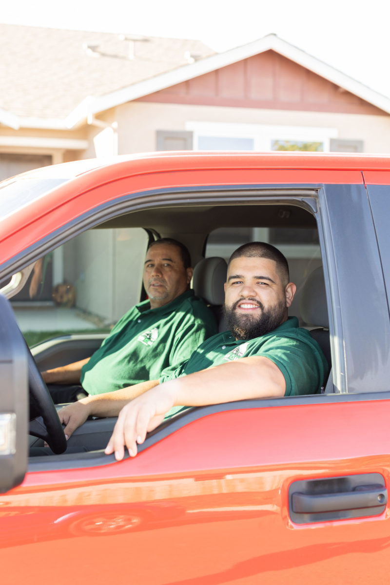 toss our junk removal smiling in junk truck ready for junk removal services